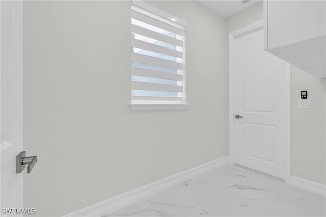 2718 42nd St W, Lehigh Acres, FL 33971 - laundry room featuring baseboards and light marble finish flooring