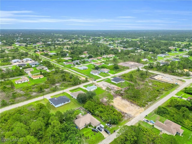 2718 42nd St W, Lehigh Acres, FL 33971 - aerial view of property and surrounding area with nearby suburban area