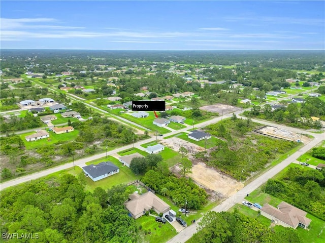 2718 42nd St W, Lehigh Acres, FL 33971 - aerial view of property and surrounding area featuring nearby suburban area