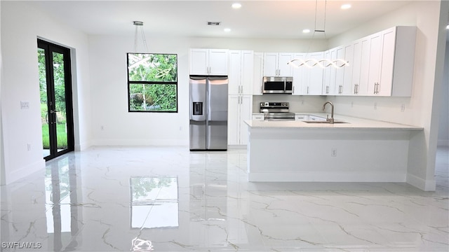 3124 40th St SW, Lehigh Acres, FL 33976 - kitchen featuring stainless steel appliances, light marble finish floors, recessed lighting, a peninsula, and pendant lighting