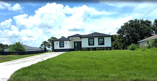 3124 40th St SW, Lehigh Acres, FL 33976 - view of front facade featuring a front lawn and stucco siding