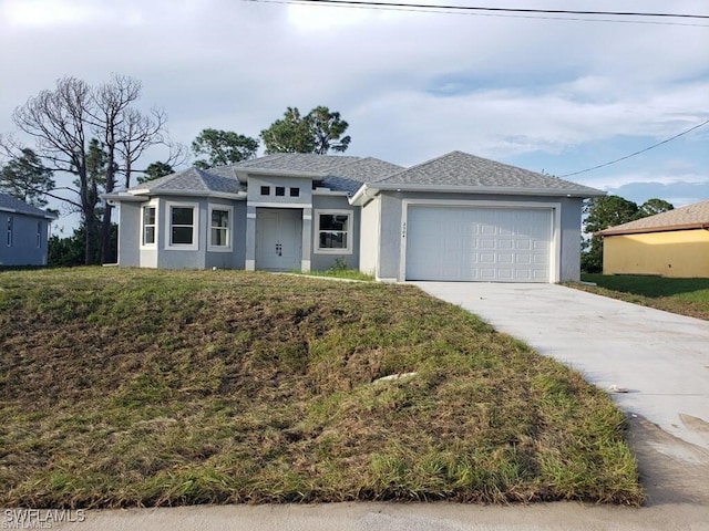 6050 Langdon Ave, Fort Myers, FL 33905 - prairie-style home with stucco siding, concrete driveway, a garage, and a shingled roof