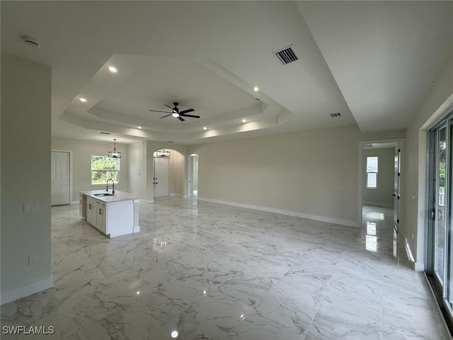 6050 Langdon Ave, Fort Myers, FL 33905 - unfurnished living room with a raised ceiling, arched walkways, and ceiling fan