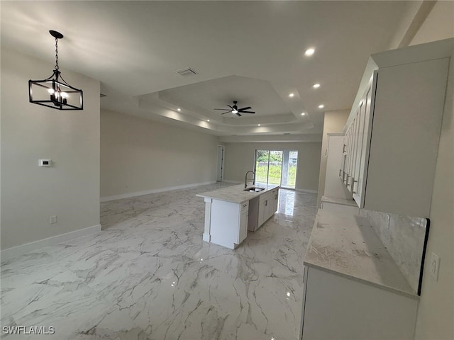 6050 Langdon Ave, Fort Myers, FL 33905 - kitchen with a raised ceiling, open floor plan, recessed lighting, a kitchen island with sink, and a ceiling fan