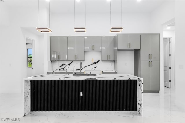2813 24th St W, Lehigh Acres, FL 33971 - kitchen with gray cabinetry, light marble finish floors, tasteful backsplash, an island with sink, and recessed lighting