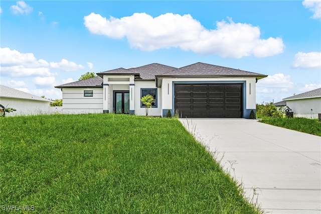 2813 24th St W, Lehigh Acres, FL 33971 - prairie-style home featuring a garage, concrete driveway, a front lawn, stucco siding, and a shingled roof