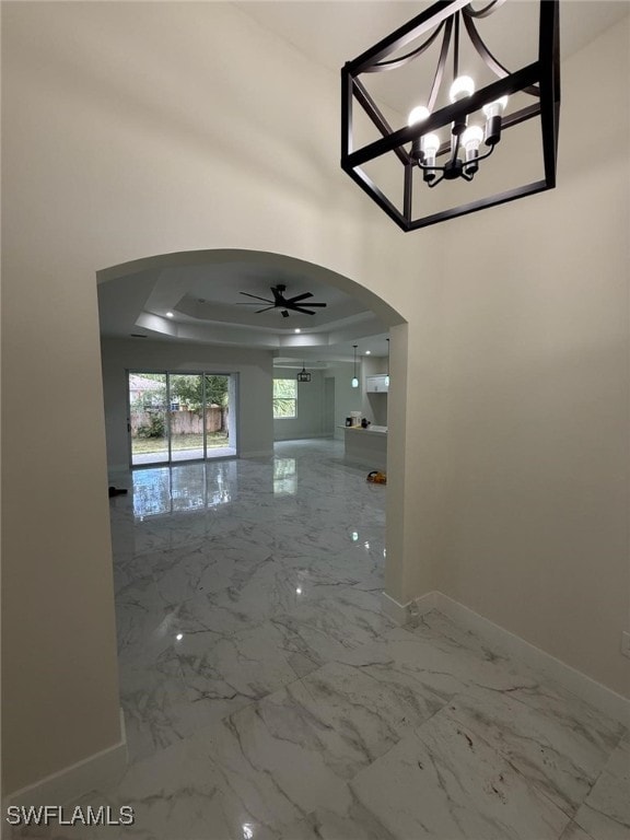 3832 Insdale St, Fort Myers, FL 33905 - corridor with arched walkways, a tray ceiling, marble finish floors, and a chandelier