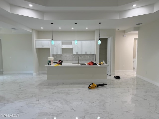3832 Insdale St, Fort Myers, FL 33905 - kitchen with recessed lighting, white cabinets, decorative backsplash, a kitchen island with sink, and decorative light fixtures