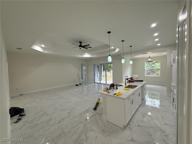 3832 Insdale St, Fort Myers, FL 33905 - kitchen with a raised ceiling, recessed lighting, open floor plan, white cabinets, and a center island with sink