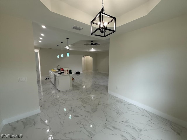 3832 Insdale St, Fort Myers, FL 33905 - unfurnished dining area with arched walkways, a ceiling fan, light marble finish flooring, and a raised ceiling
