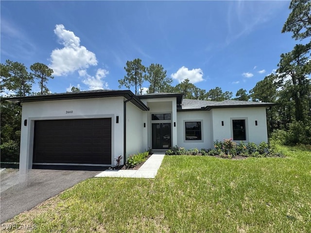 2660 18th Ave NE, Naples, FL 34120 - view of front of home featuring an attached garage, stucco siding, asphalt driveway, and a front yard