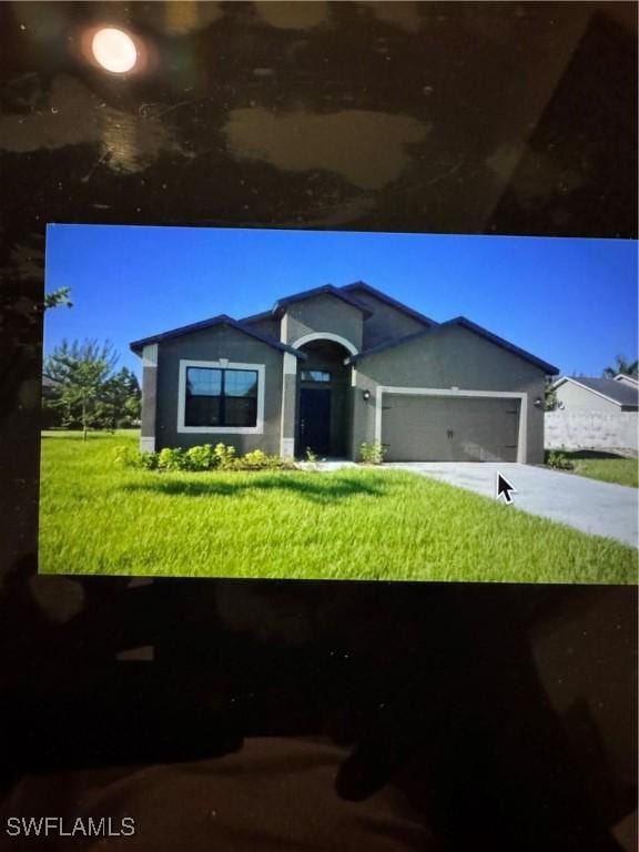 922 SW 36th St, Cape Coral, FL 33914 - ranch-style home featuring a front lawn, driveway, a garage, and stucco siding