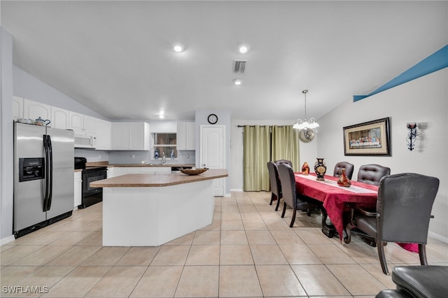 3031 36th St SW, Lehigh Acres, FL 33976 - kitchen featuring stainless steel refrigerator with ice dispenser, electric range, vaulted ceiling, white microwave, and a chandelier