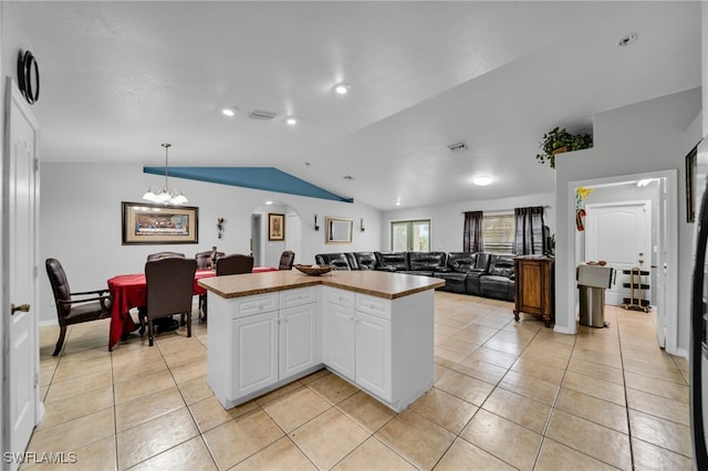 3031 36th St SW, Lehigh Acres, FL 33976 - kitchen featuring open floor plan, lofted ceiling, a chandelier, light tile patterned floors, and white cabinetry