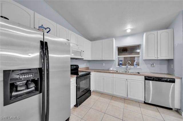3031 36th St SW, Lehigh Acres, FL 33976 - kitchen with appliances with stainless steel finishes, light countertops, white cabinetry, light tile patterned floors, and lofted ceiling