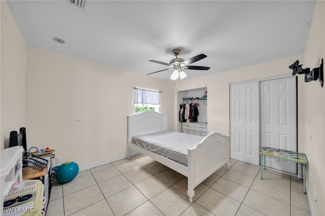 3031 36th St SW, Lehigh Acres, FL 33976 - bedroom with light tile patterned floors, ceiling fan, and multiple closets