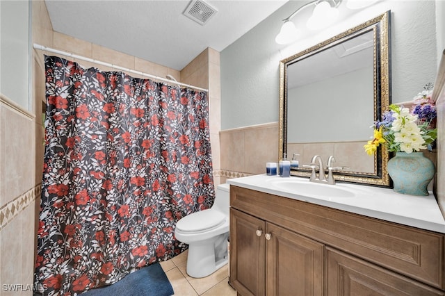 3031 36th St SW, Lehigh Acres, FL 33976 - full bathroom with vanity, tile patterned flooring, tile walls, curtained shower, and a wainscoted wall