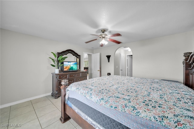 3031 36th St SW, Lehigh Acres, FL 33976 - bedroom featuring arched walkways, light tile patterned floors, and a ceiling fan