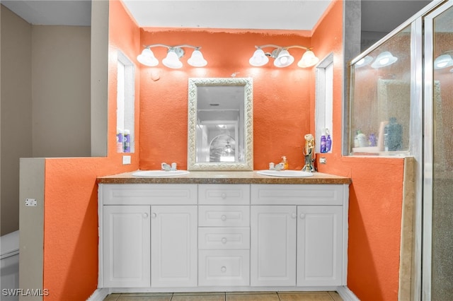 3031 36th St SW, Lehigh Acres, FL 33976 - bathroom featuring double vanity, a shower stall, and a textured wall