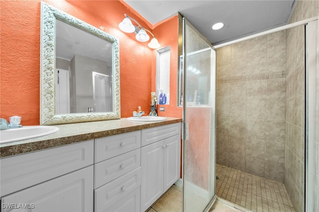 3031 36th St SW, Lehigh Acres, FL 33976 - bathroom with double vanity, a stall shower, a textured wall, and tile patterned flooring
