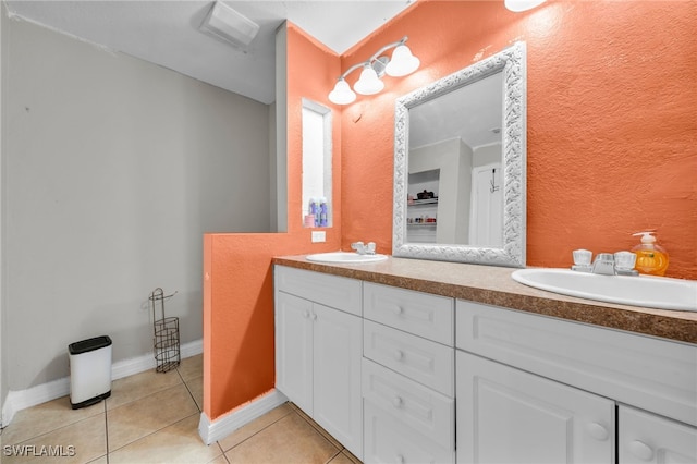 3031 36th St SW, Lehigh Acres, FL 33976 - bathroom with double vanity, tile patterned floors, and a textured wall