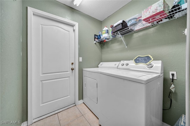 3031 36th St SW, Lehigh Acres, FL 33976 - washroom featuring washing machine and dryer and light tile patterned floors