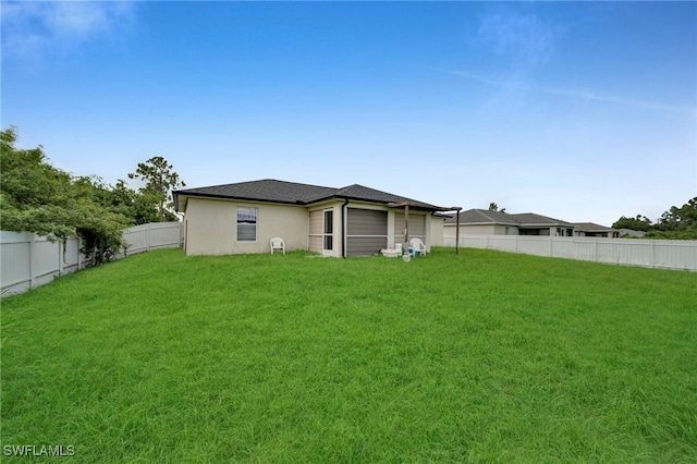3031 36th St SW, Lehigh Acres, FL 33976 - rear view of house with a fenced backyard and stucco siding