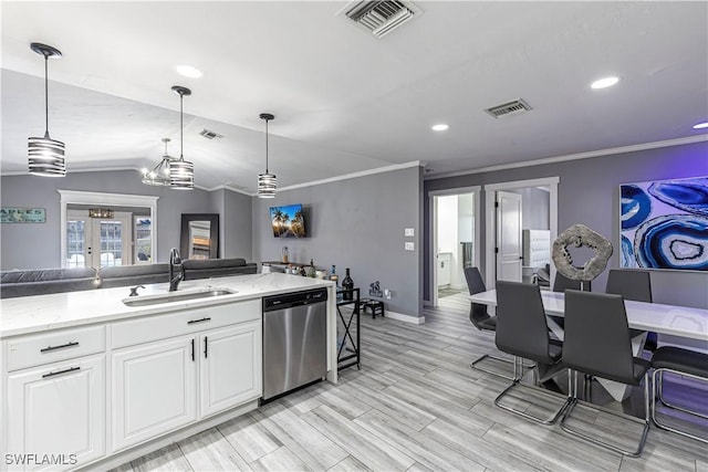 754 105th Ave N, Naples, FL 34108 - kitchen with stainless steel dishwasher, french doors, white cabinetry, ornamental molding, and open floor plan