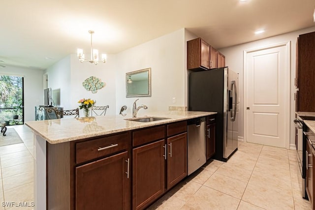 7907 Bristol Cir, Naples, FL 34120 - kitchen featuring stainless steel appliances, a peninsula, light tile patterned floors, light stone countertops, and recessed lighting