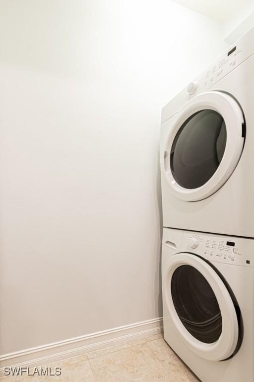7907 Bristol Cir, Naples, FL 34120 - washroom featuring stacked washer / drying machine and baseboards