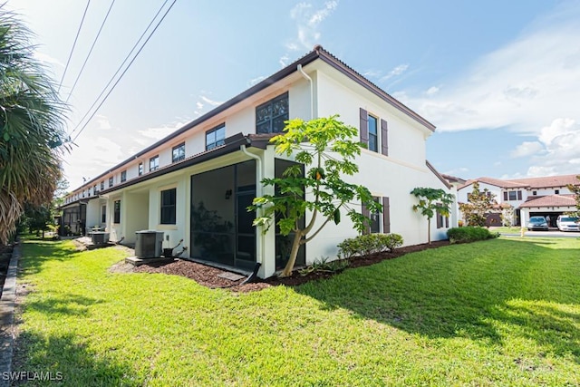 7907 Bristol Cir, Naples, FL 34120 - back of property featuring stucco siding and a yard