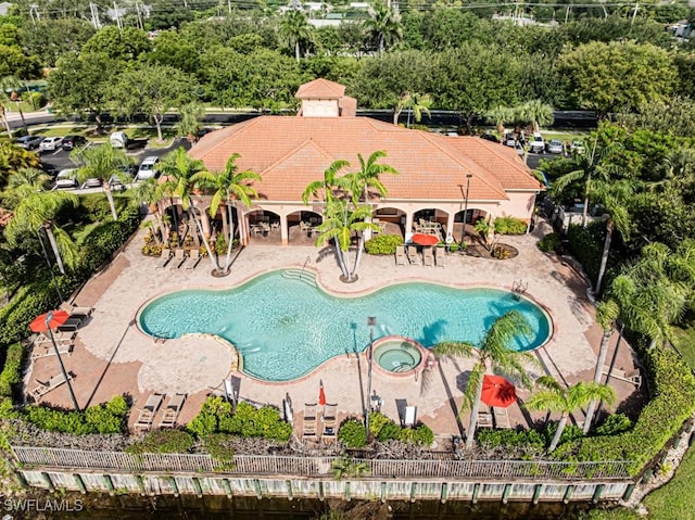 7907 Bristol Cir, Naples, FL 34120 - view of swimming pool featuring a patio area, a pool with connected hot tub, and view of scattered trees