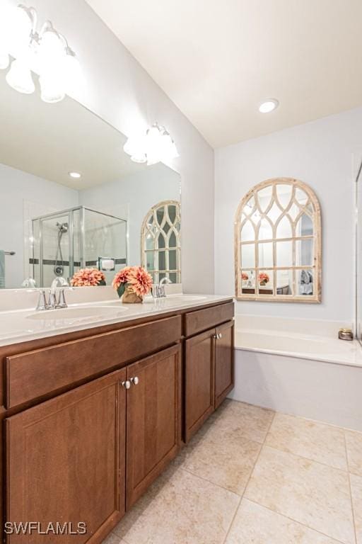7907 Bristol Cir, Naples, FL 34120 - full bathroom featuring a bath, double vanity, a shower stall, and tile patterned floors