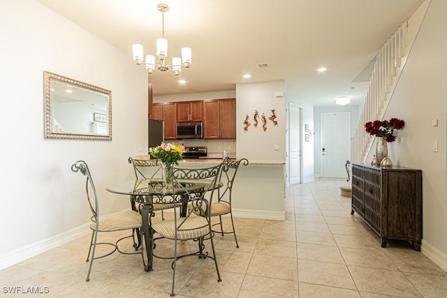 7907 Bristol Cir, Naples, FL 34120 - dining room with a chandelier, recessed lighting, light tile patterned floors, and stairway