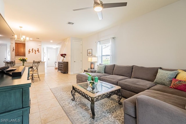 7907 Bristol Cir, Naples, FL 34120 - living area featuring light tile patterned floors, ceiling fan, and a chandelier