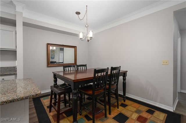 11500 Villa Grand Unit 310, Fort Myers, FL 33913 - dining room with crown molding, a chandelier, and dark wood-style flooring