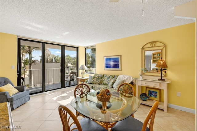 8701 Estero Blvd Unit 105, Bonita Springs, FL 33931 - dining room featuring a textured ceiling, light tile patterned floors, and expansive windows