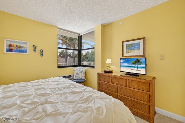 8701 Estero Blvd Unit 105, Bonita Springs, FL 33931 - carpeted bedroom with baseboards and a textured ceiling