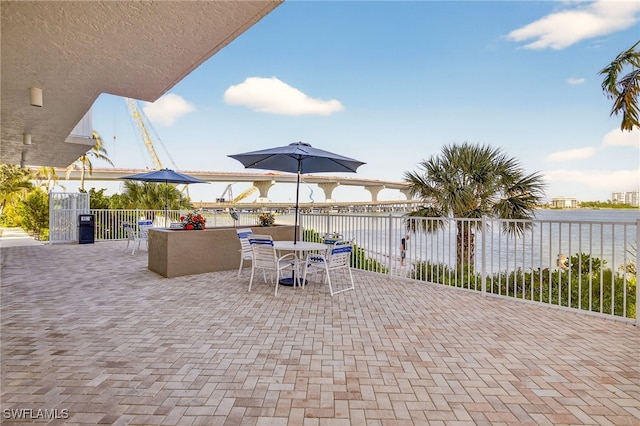 8701 Estero Blvd Unit 105, Bonita Springs, FL 33931 - view of patio / terrace with a water view and outdoor dining space