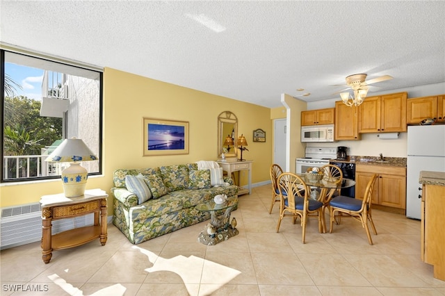 8701 Estero Blvd Unit 105, Bonita Springs, FL 33931 - living area with a textured ceiling, light tile patterned flooring, and a ceiling fan