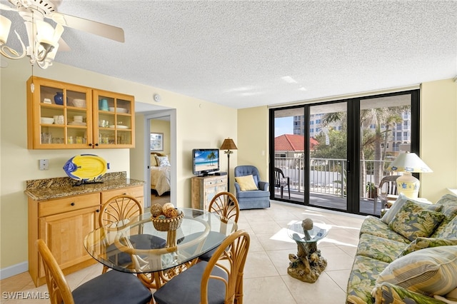 8701 Estero Blvd Unit 105, Bonita Springs, FL 33931 - dining space with light tile patterned flooring, a textured ceiling, expansive windows, and ceiling fan