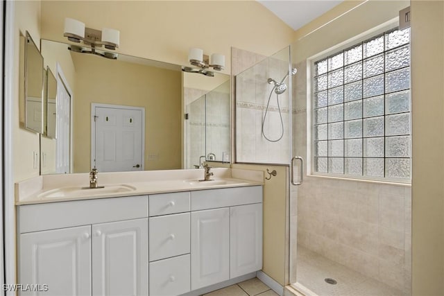 17936 Courtside Landings Cir, Punta Gorda, FL 33955 - bathroom featuring a stall shower, healthy amount of natural light, double vanity, and tile patterned flooring