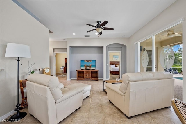 17936 Courtside Landings Cir, Punta Gorda, FL 33955 - living room with ceiling fan, arched walkways, recessed lighting, and light tile patterned floors