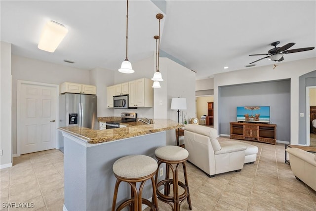 17936 Courtside Landings Cir, Punta Gorda, FL 33955 - kitchen with appliances with stainless steel finishes, cream cabinets, a ceiling fan, open floor plan, and recessed lighting