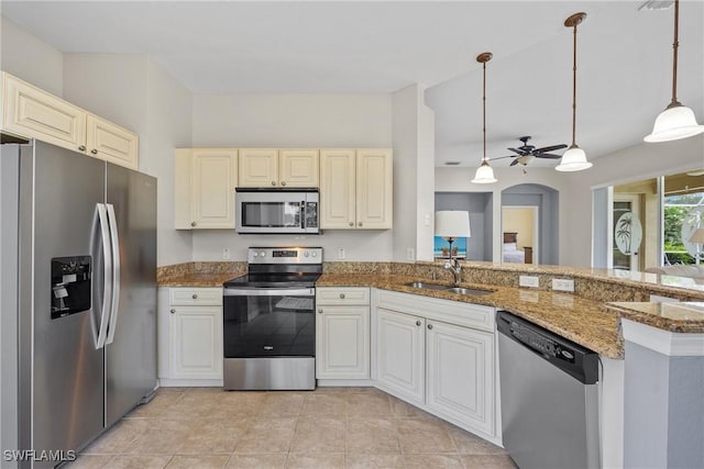 17936 Courtside Landings Cir, Punta Gorda, FL 33955 - kitchen featuring appliances with stainless steel finishes, a ceiling fan, stone counters, pendant lighting, and cream cabinetry