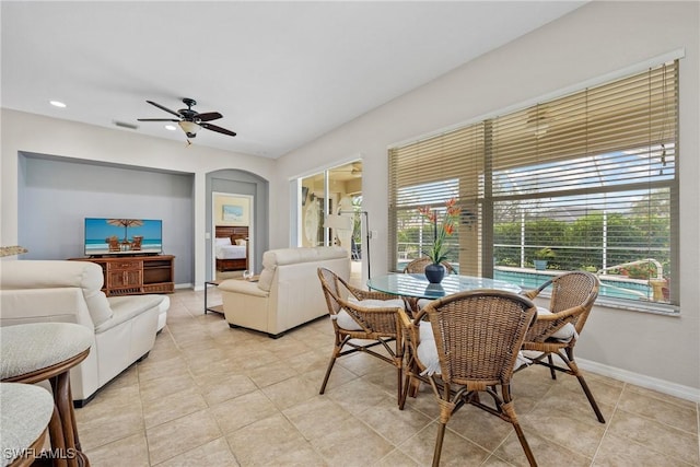 17936 Courtside Landings Cir, Punta Gorda, FL 33955 - dining area with arched walkways, a ceiling fan, recessed lighting, and light tile patterned flooring