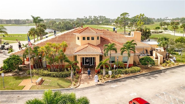 17936 Courtside Landings Cir, Punta Gorda, FL 33955 - mediterranean / spanish home featuring a tiled roof, stucco siding, and a chimney