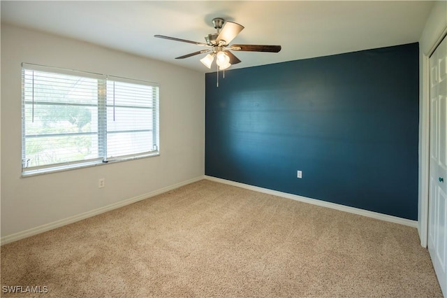 180 Cypress Way E Unit B212, Naples, FL 34110 - unfurnished room with carpet floors and ceiling fan