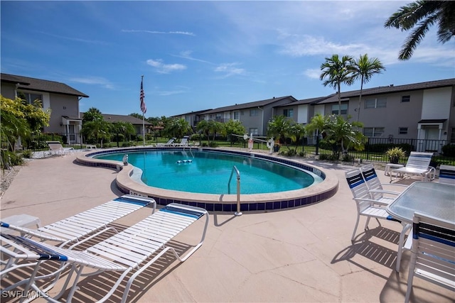 180 Cypress Way E Unit B212, Naples, FL 34110 - community pool with a patio and a residential view