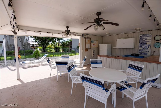 180 Cypress Way E Unit B212, Naples, FL 34110 - view of patio featuring outdoor dining space and ceiling fan